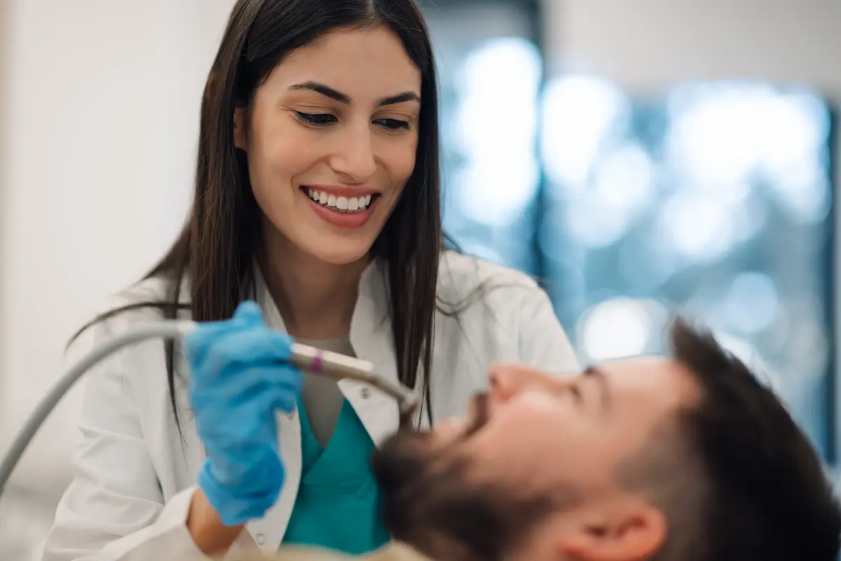 female-dentist-performing-dental-procedure-on-male-2025-04-03-21-15-19-utc