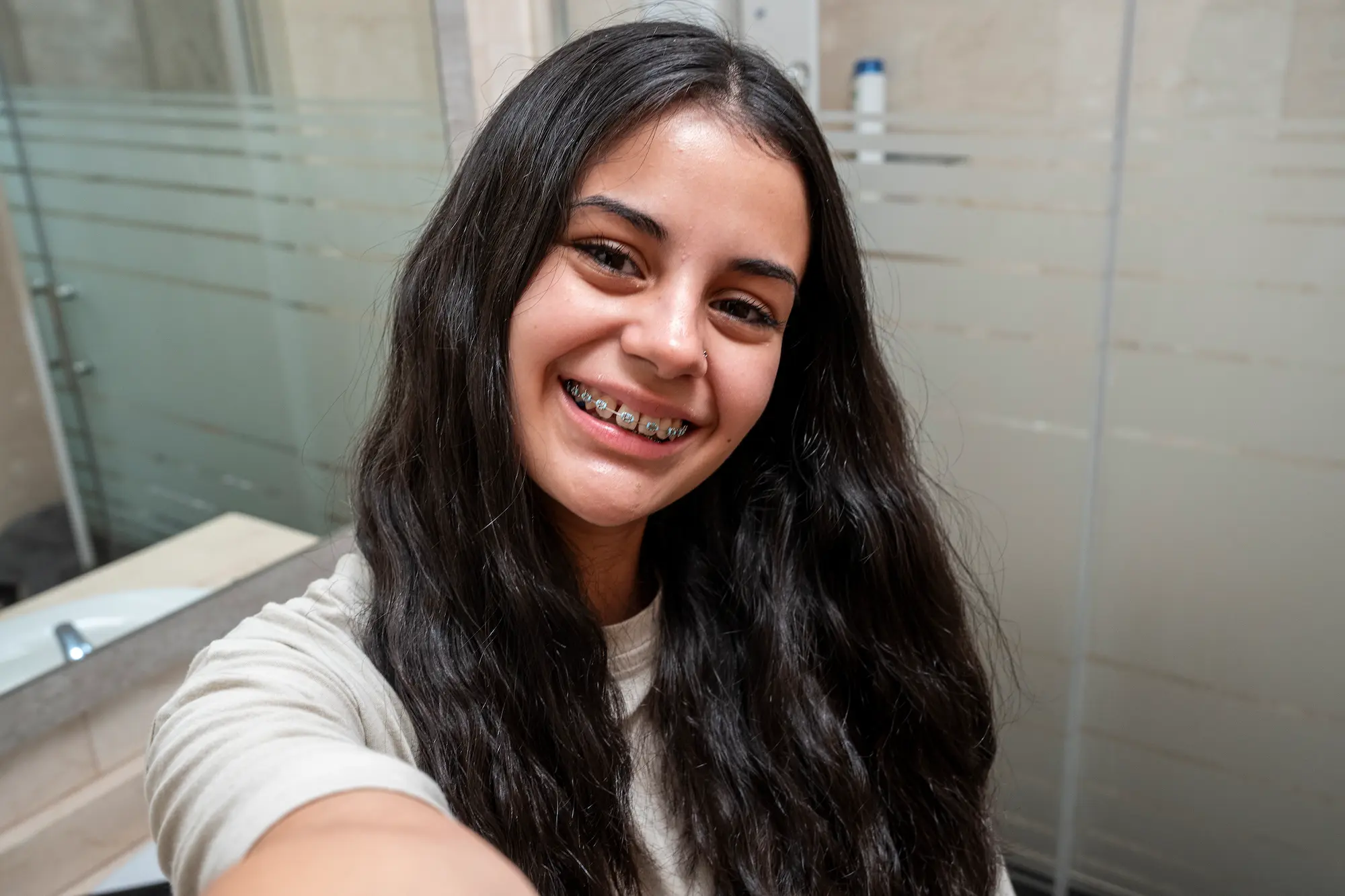 smiling-brunette-teen-with-braces-taking-a-selfie-2025-09-09-20-23-14-utc